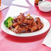 General Tso's Chicken · Pieces of crispy chicken served in a spicy sauce of seared red peppers and onions. Spicy.