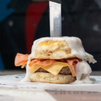 The Freddy D · A ¼ bacon beef blend patty, grilled ham, melted American cheese, fried egg on biscuit buns a...