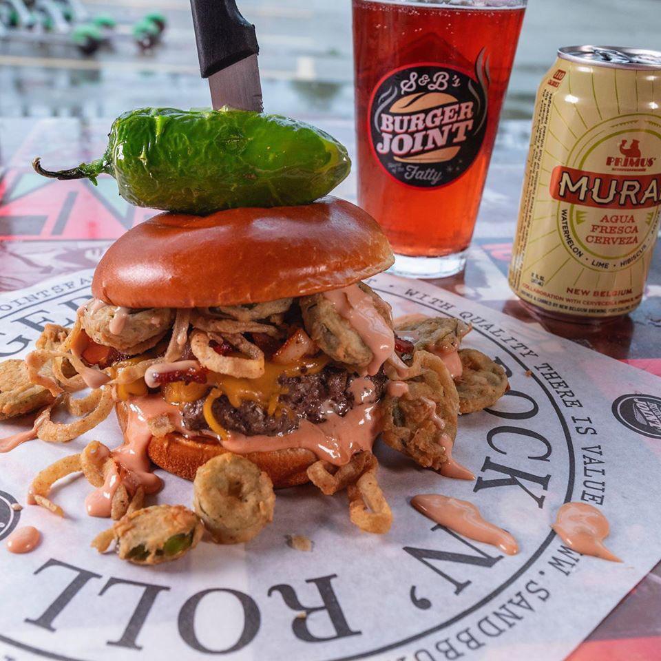 The Old Town Road Burger · 1/2 lb. beef patty, yellow cheddar, bacon, hand-breaded fried jalapenos & onions, BBQ aioli, brioche bun, whole fried jalapeno.
