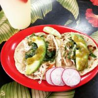 Chicken Tinga Taco · Served on hand pressed tortillas, cilantro, onion and homemade guacamole.