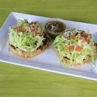 2 Sopes · Choice of meat. Beans, lettuce, tomato, onion, cheese and sour cream.