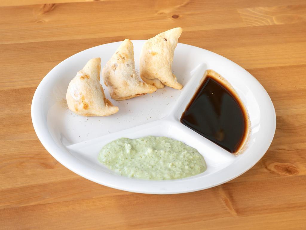 Vegetable Samosa · The most popular Indian appetizer.  Deep fried pastry stuffed with potatoes and peas. Dairy free, vegan, nut free, gluten free, vegetarian.