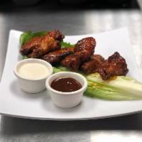 Wings (8) · Sauteed in our homemade guajillo-BBQ sauce. Served with ranch dressing on the side.