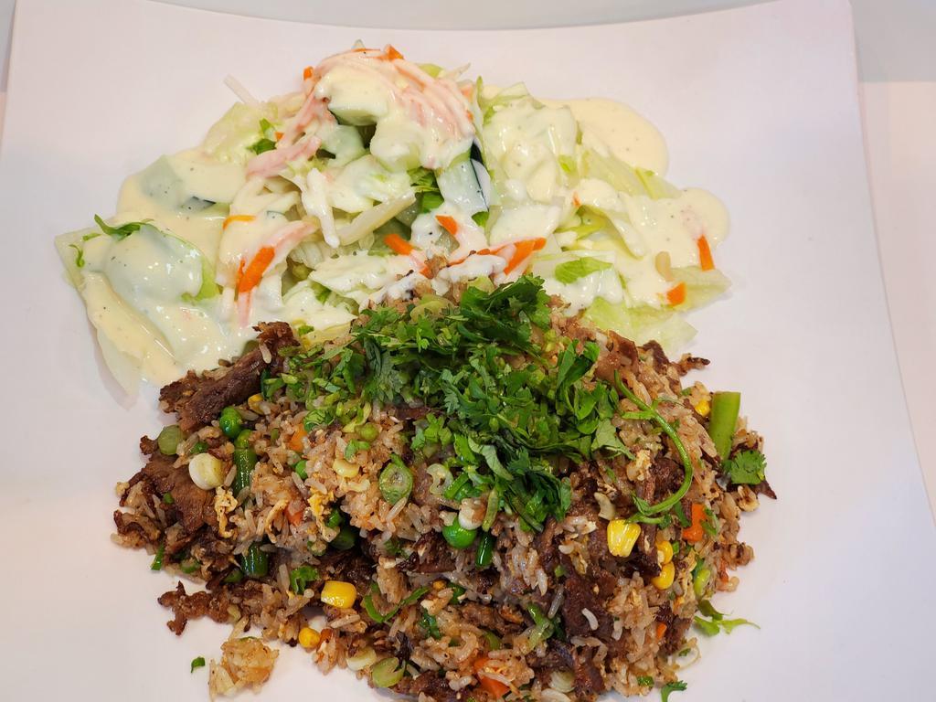 30. Beef Fried Rice · Served w/salad - topped w/scallion & cillantro