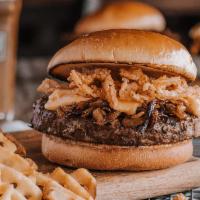 CRAFTED BEER BURGER · USDA Choice ground chuck burger grilled with a light lager & smothered in caramelized onions...