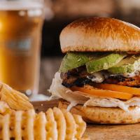 CALIFORNIA CHICKEN SANDWICH · Grilled chicken breast, Swiss & avocado, lettuce, tomato & a dab of house-made ranch on a br...
