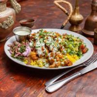 Chicken Shawarma Plate · Shawarma Chicken on a bed of rice with a side of Jineen salad (cucumbers, fresh parsley, and...