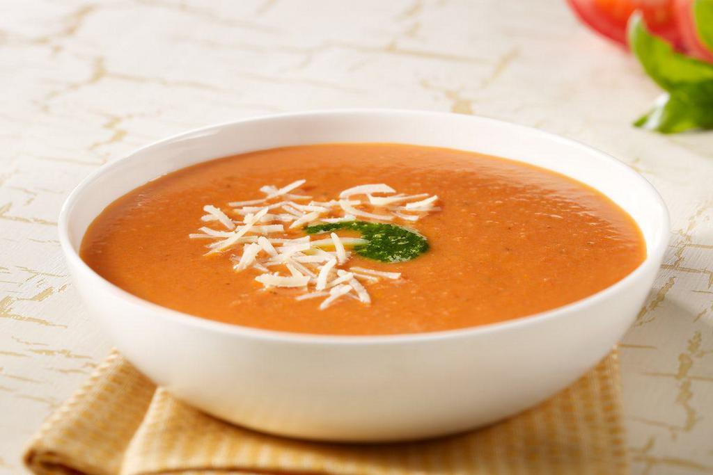 Tomato Basil · Fresh, ripe tomatoes, basil and onions blended into a smooth, creamy soup. Topped with croutons and parmesan cheese.