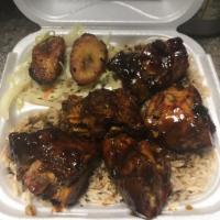 BBQ Jerk Chicken · Jerk Chicken tossed in our Homemade BBQ Sauce. Comes with rice and peas, cabbage, and planta...