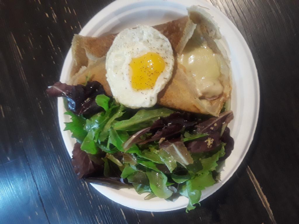 CP9. La Complete Madame Crepe · Crepe with bechamel sauce, parisian ham Swiss cheese and Sunny Side Up egg. Served with a side of mesclun mix salad. Made with buckwheat flour imported from France. Gluten free.