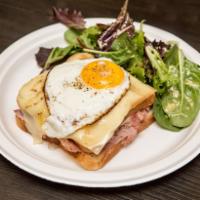 CM2. Croque Madame · White bread with bechamel sauce, French ham and melted Swiss cheese topped with 1 egg sunny ...