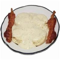 Biscuits and Gravy Breakfast · Two freshly baked buttermilk biscuits with country gravy and bacon or sausage.