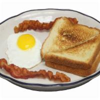 #7 One Egg Breakfast · One egg cooked to order, two pieces of bacon or sausage and buttered toast with jelly.