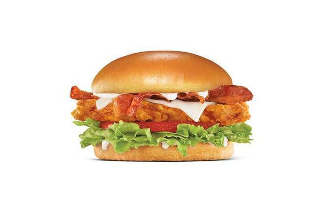 Hand-Breaded Bacon Swiss Chicken Sandwich · Premium, all-white chicken fillet, hand-dipped in buttermilk, lightly breaded and fried to a golden brown, topped with bacon, Swiss cheese, lettuce, tomato, and mayonnaise on a potato bun.