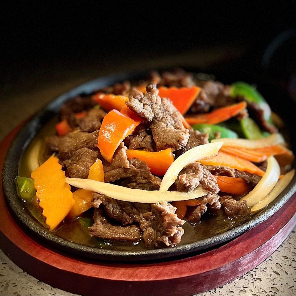 Beef Sizzling · Flank beef, carrot, bell pepper, and onion on the hot plate.