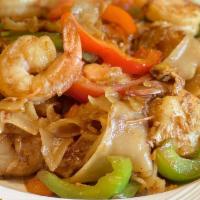 Pad Kee Mow (Drunken Noodles) · Wok tossed, big flat rice noodles, egg, garlic, chilies, bell pepper, tomatoes, and basil le...
