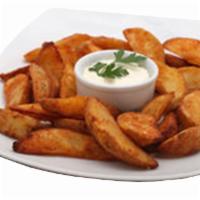 Potato Wedges · Oven baked potato wedges served with ketchup or ranch.