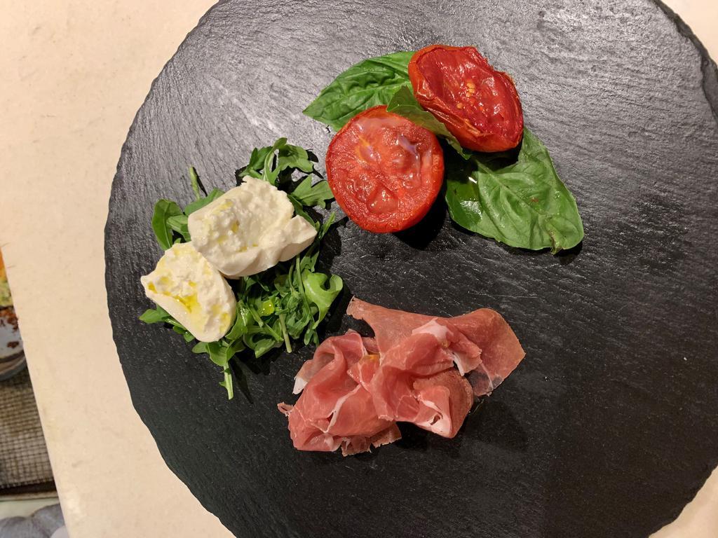 A Taste of Italy · Napoli semi-dry tomato, puglia burrata and prosciutto di San Daniele with arugula and extra virgin olive oil.