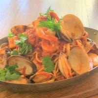 Seafood Pescatore · Spaghetti sauteed with clams, shrimps, scallops and squid in a spicy tomato sauce.