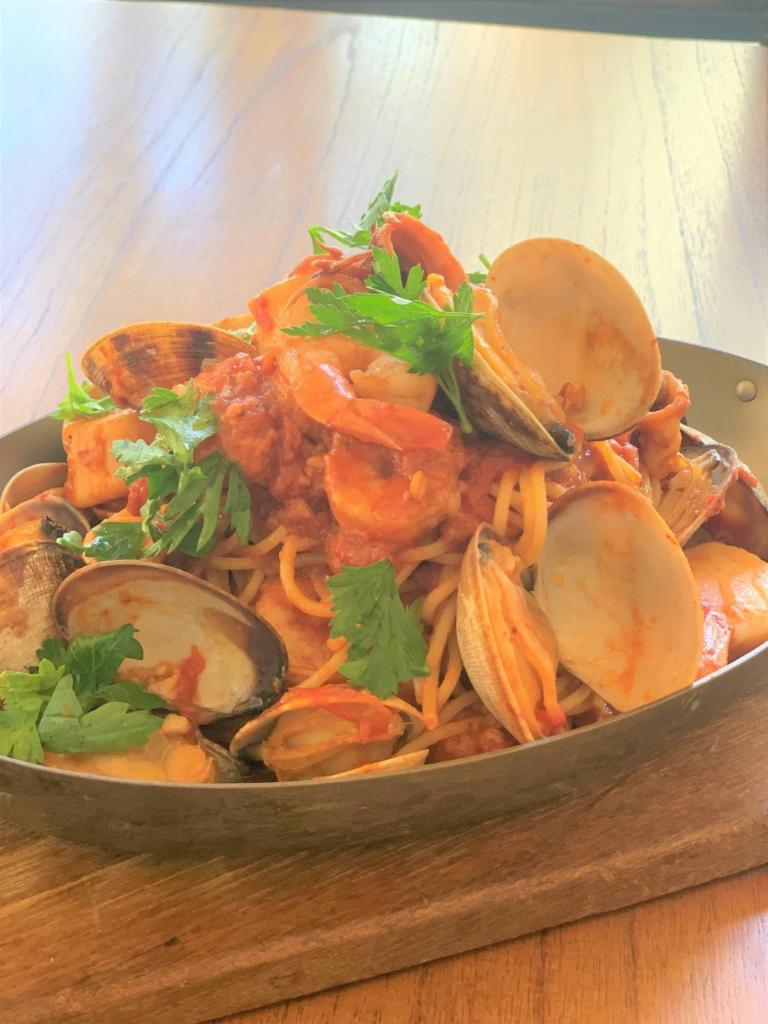 Seafood Pescatore · Spaghetti sauteed with clams, shrimps, scallops and squid in a spicy tomato sauce.