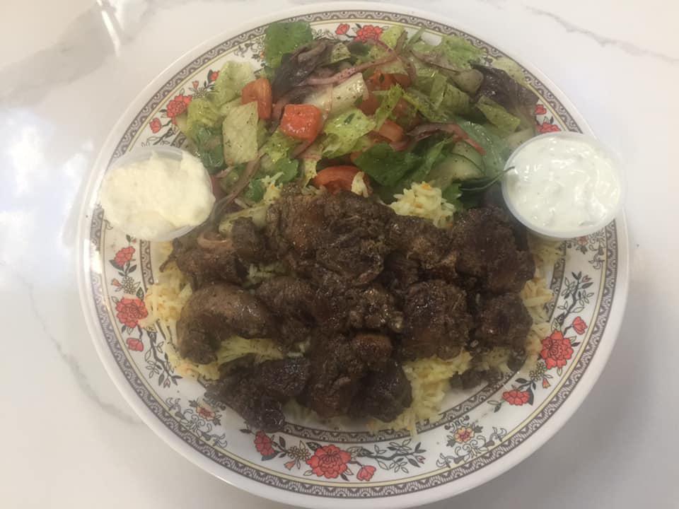 14. Chop Chop Chicken Liver · Chicken liver sautéed with garlic, lemon juice, and spices served with rice pilaf, salad, tzatziki, and garlic sauce.