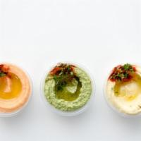 Mezza Trio · Sample any 3 spreads of your choice. Served with pita bread. Vegetarian.