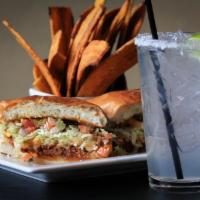 Garlic Shredded Beef Sandwich · Served with fried plantains, made on grilled torta bread with roasted garlic aioli sauce, ch...