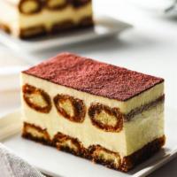 Tiramisu · Layers of espresso drenched ladyfingers cream and dusted with cocoa powder.