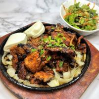 Korean BBQ Spicy Pork Appetizer · Grilled Korean spicy pork on a bed of sautéed onions, served with Korean lettuce salad & 2pc...