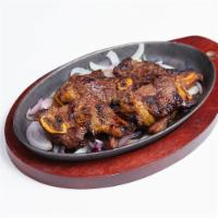 Baby Short Ribs · Korean style grilled marinated baby short ribs, served with onion.
