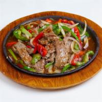 Mongolian Skillet Beef · Marinated slices and sauteed with ginger scallions, onions and bell peppers with chef's brow...