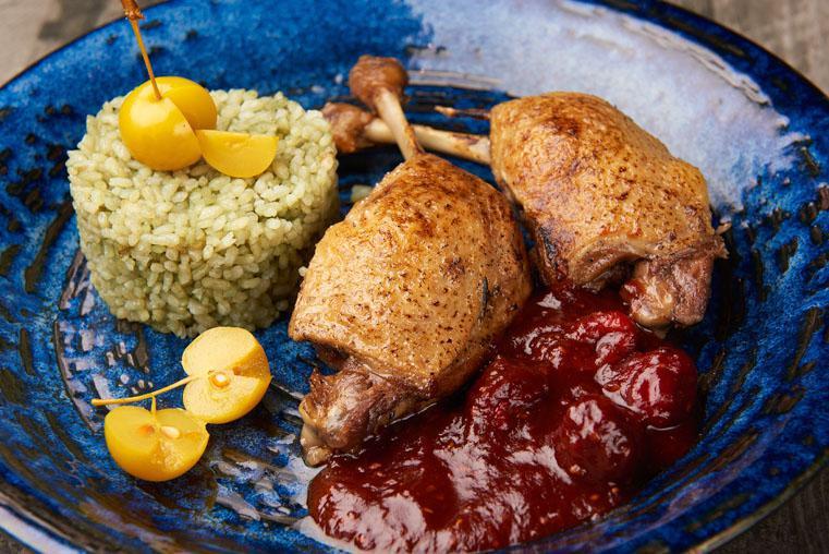 Duck Confit · 2 duck legs, under cherry sauce, served with rice.