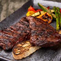 Grilled Skirt Steak · Marinated whole skirt steak, grilled to your taste, served with vegetables.