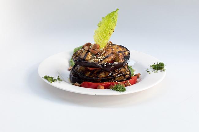 Stuffed Halloumi · Grilled layers of Halloumi cheese, tomatoes, & eggplant topped w/ balsamic vinegar & toasted almonds