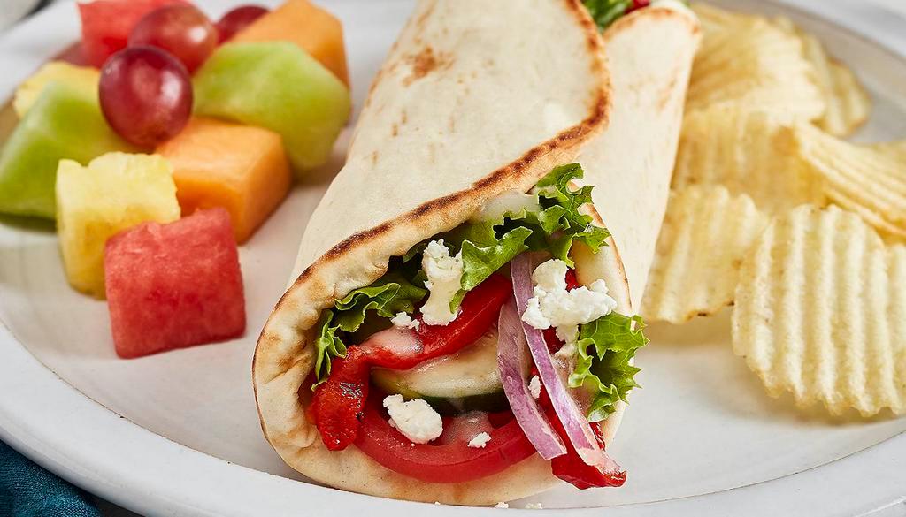 Greek Salad Gyro · Tomatoes, cucumbers, roasted red peppers, red onions, mixed lettuce, feta, and Greek dressing. Served with chips and your choice of a homemade side
