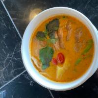 Roasted Duck Curry · Red curry with Tomatoes, Pineapple, Bell peppers, And fresh basils.