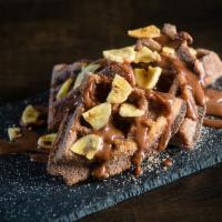 Nutella Banana Chuffles · bowl of cinnamon sugar tossed churro waffles with nutella banana sauce, topped with crushed ...