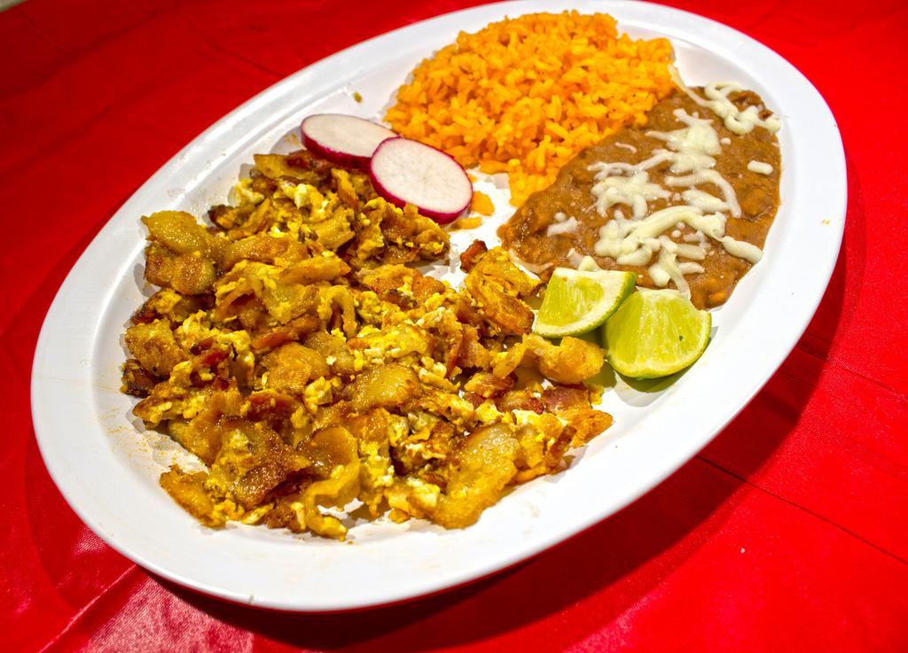 Huevos Rancheros · Our Huevos Rancheros consists of: Your choice of honey ham, honey smoke bacon, or mexican chorizo cooked on the griddle mixed with scrambled or sunny side up eggs, a side of spanish rice, pot beans, served with your choice of corn or flour tortillas.