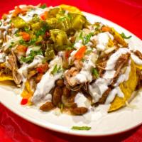 Nachos · Our Nachos consists of: House made corn tortilla chips, piled with your choice of meat, pot ...