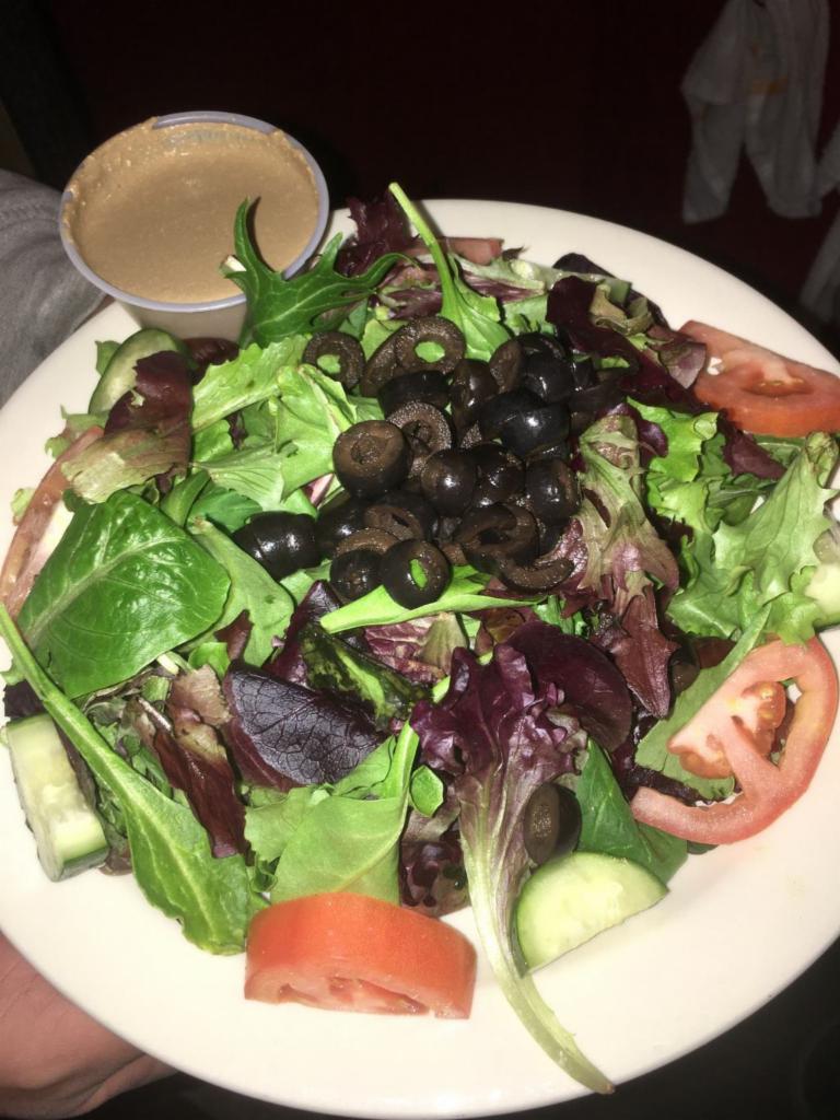 Garden Salad · Mixed greens lettuce with tomato, cucumbers, and black olives with our house balsamic vinaigrette on the side. Gluten free.