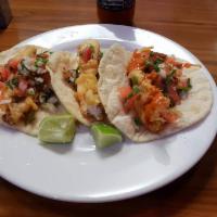 Tacos de Pescado · Fried tilapia fish topped with lettice, pico de gallo and cheese.