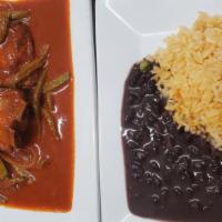 Costilla Platillo · Pork ribs in red or green sauce. Served with rice, beans and salad.