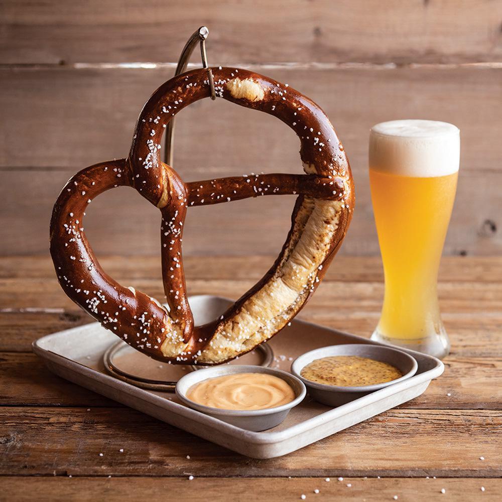 German Pretzel · A giant Bavarian pretzel as big as your head, baked soft on the inside, crispy on the outside and salted. Served with house-made stone ground mustard. Add our amber ale beer cheese for an additional charge.
