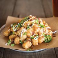 Loaded Taters · Tater tots loaded with our Amber Ale beer cheese and topped with fresh jalapenos, apple wood...