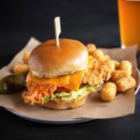 Crispy Buffalo Chicken Sandwich · Lightly hand-breaded beer-brined chicken breast tossed in spicy Buffalo sauce and topped wit...