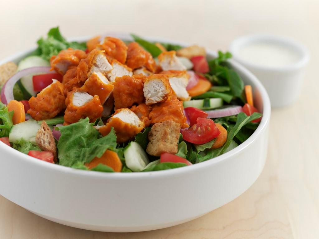 Buffalo Chicken Salad · Grilled or fried chicken tossed in Buffalo medium sauce, assorted greens, shredded carrots, cucumbers, tomatoes, red onions, croutons, and ranch dressing.