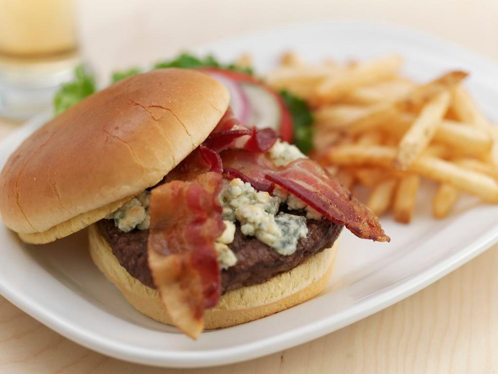 Black and Bleu Burger · Seared with Cajun spices, topped with melted bleu cheese crumbles, applewood-smoked bacon and our famous bleu cheese dip. Served on a brioche bun with lettuce, tomato and pickles.