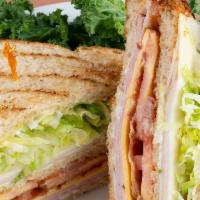 Club Supreme · Smoked ham and turkey layered on toasted honey wheat bread with bacon, American and Swiss ch...
