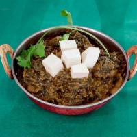 Palak Paneer · Cottage cheese cubes cooked with fresh spinach and herbs. Gluten free.