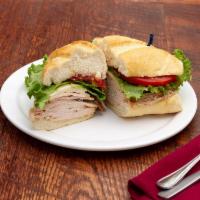 Mikey’s Sandwich · Smoked turkey, muenster, oil or vinegar, lettuce, tomato, and sweet peppers on a French roll.